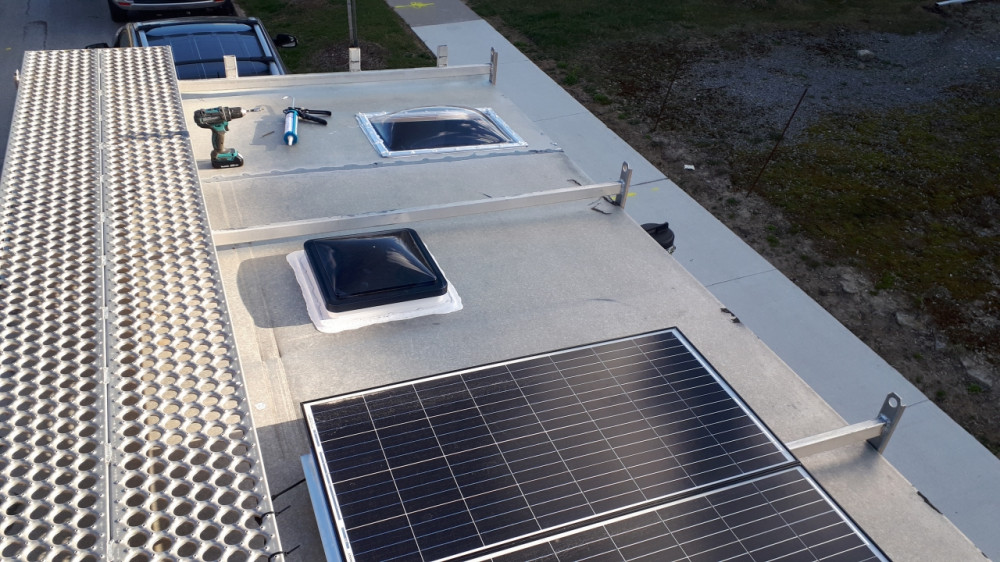 Roof is complete: We got a skylight, a vent and solar panels installed.
